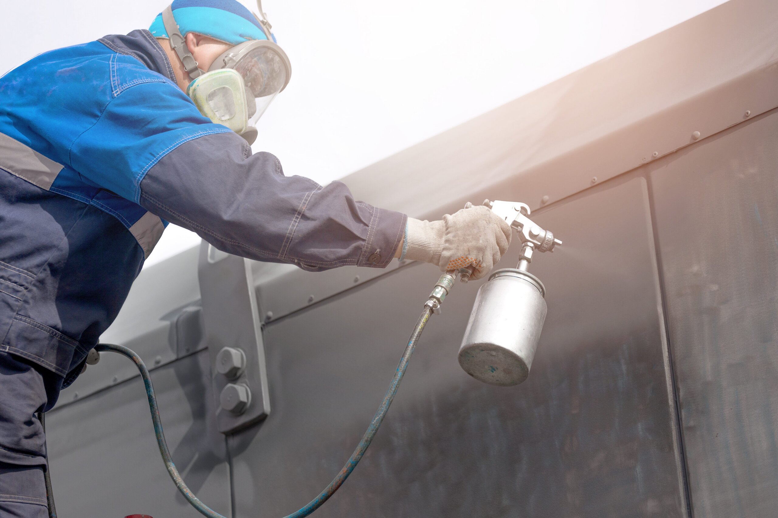 expert working on storefront electrostatic painting