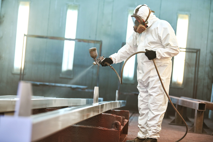 electrostatic painter spraying electrostatic coating at a store